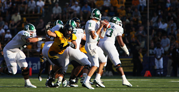 Defensive lineman Tyson Alualu goes after Michigan St. QB Brian Hoyer