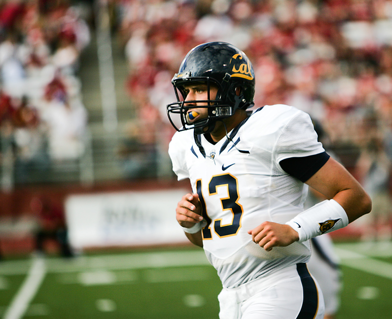 California quarterback Kevin Riley jogs back to the sideline